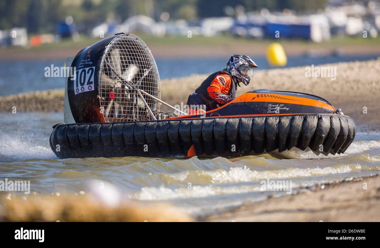 A hovercraft driver speeds along the race course at the ...