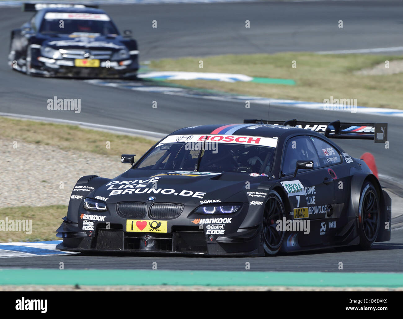 Canadian BMW driver Bruno Spengler leads the field in front of British Mercedes driver Gary Paffett during the eighth race of the German Touring Car Masters (DTM) in Oschersleben, Germany, 16 September 2012. Photo: JENS WOLF Stock Photo