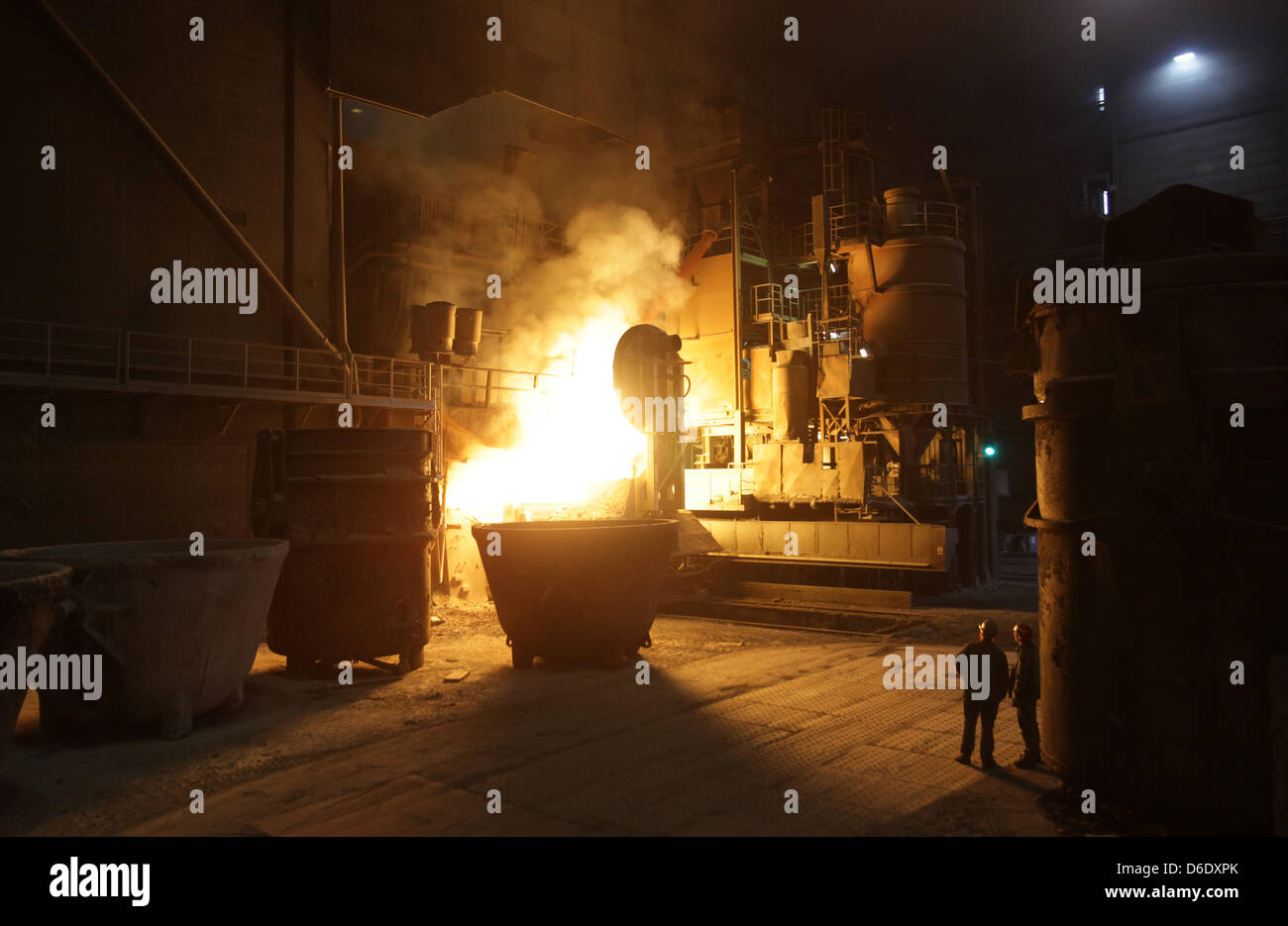 Workers watch the steel tapping at the steel plant of the steel