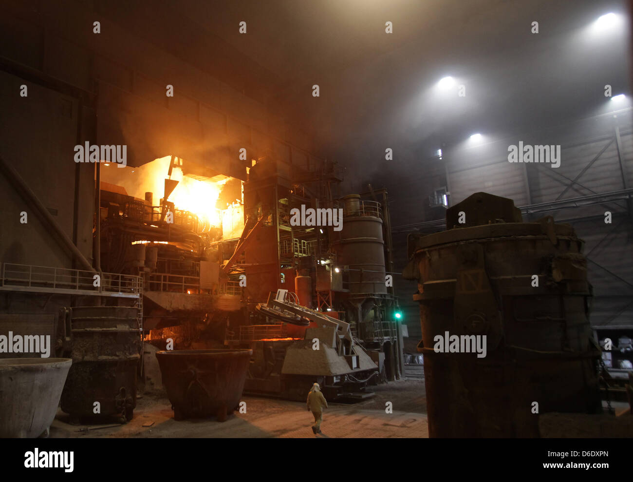 Workers watch the steel tapping at the steel plant of the steel