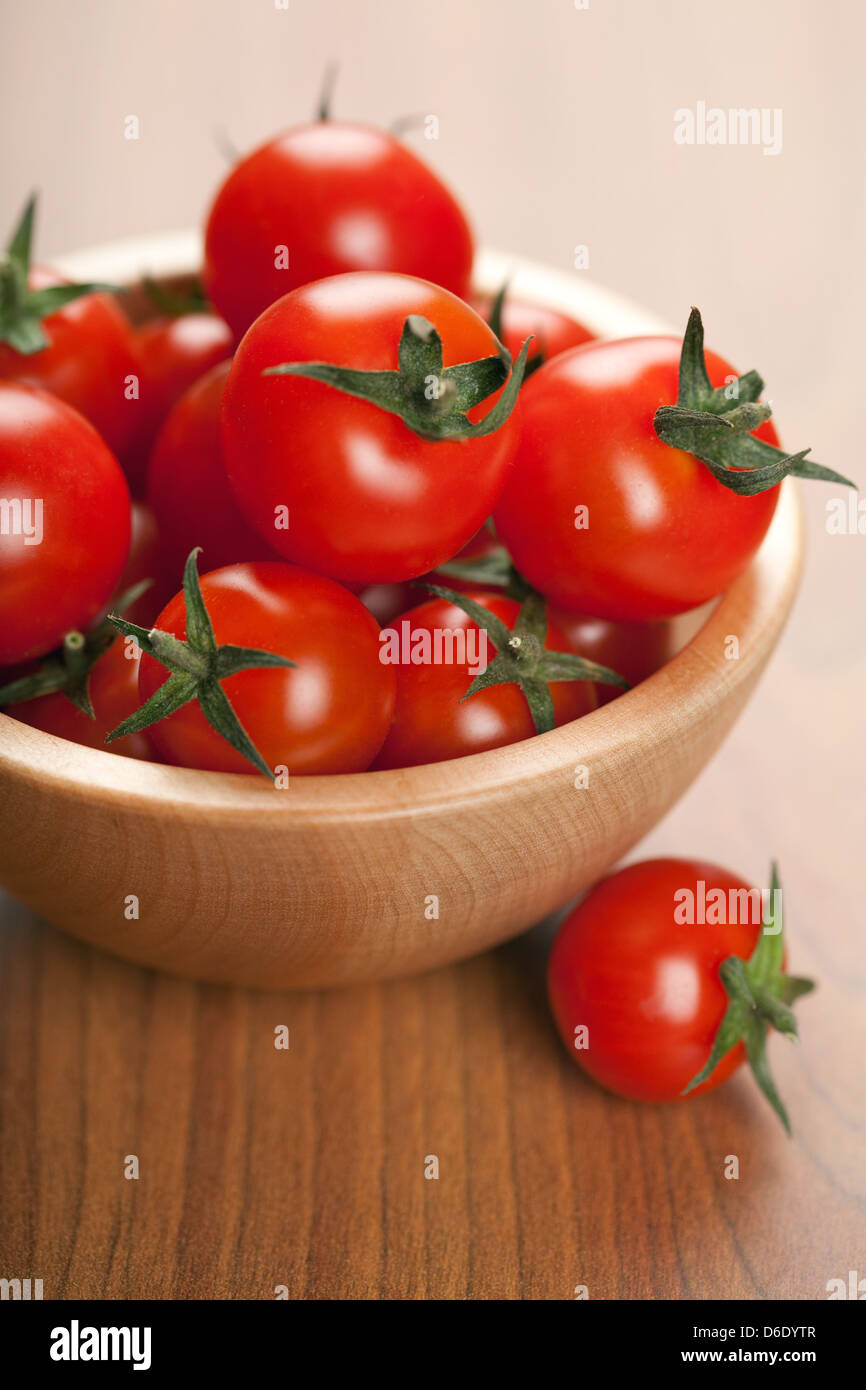 ripe tomatoes in wooden bowl Stock Photo - Alamy