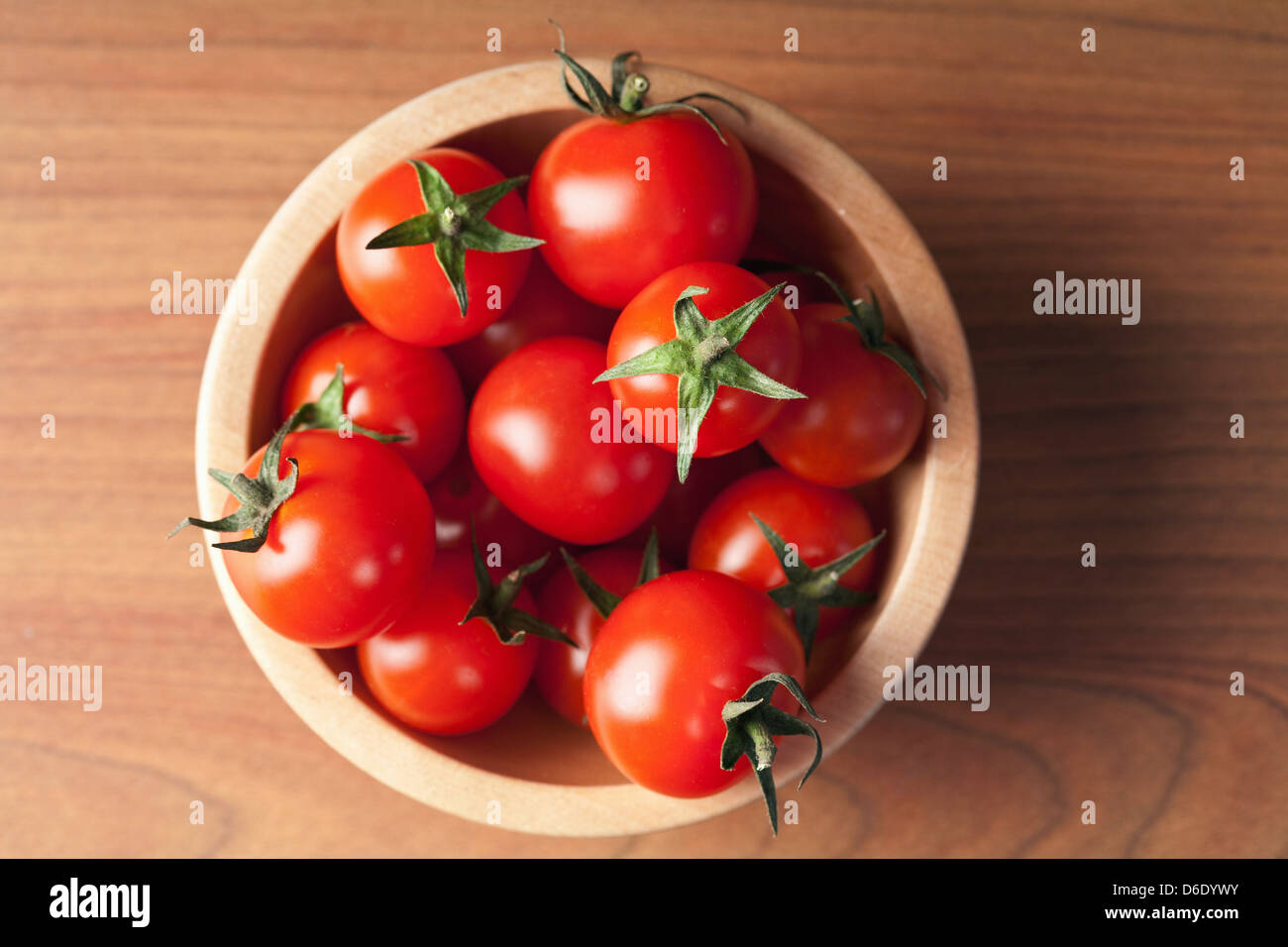 ripe tomatoes in wooden bowl Stock Photo - Alamy