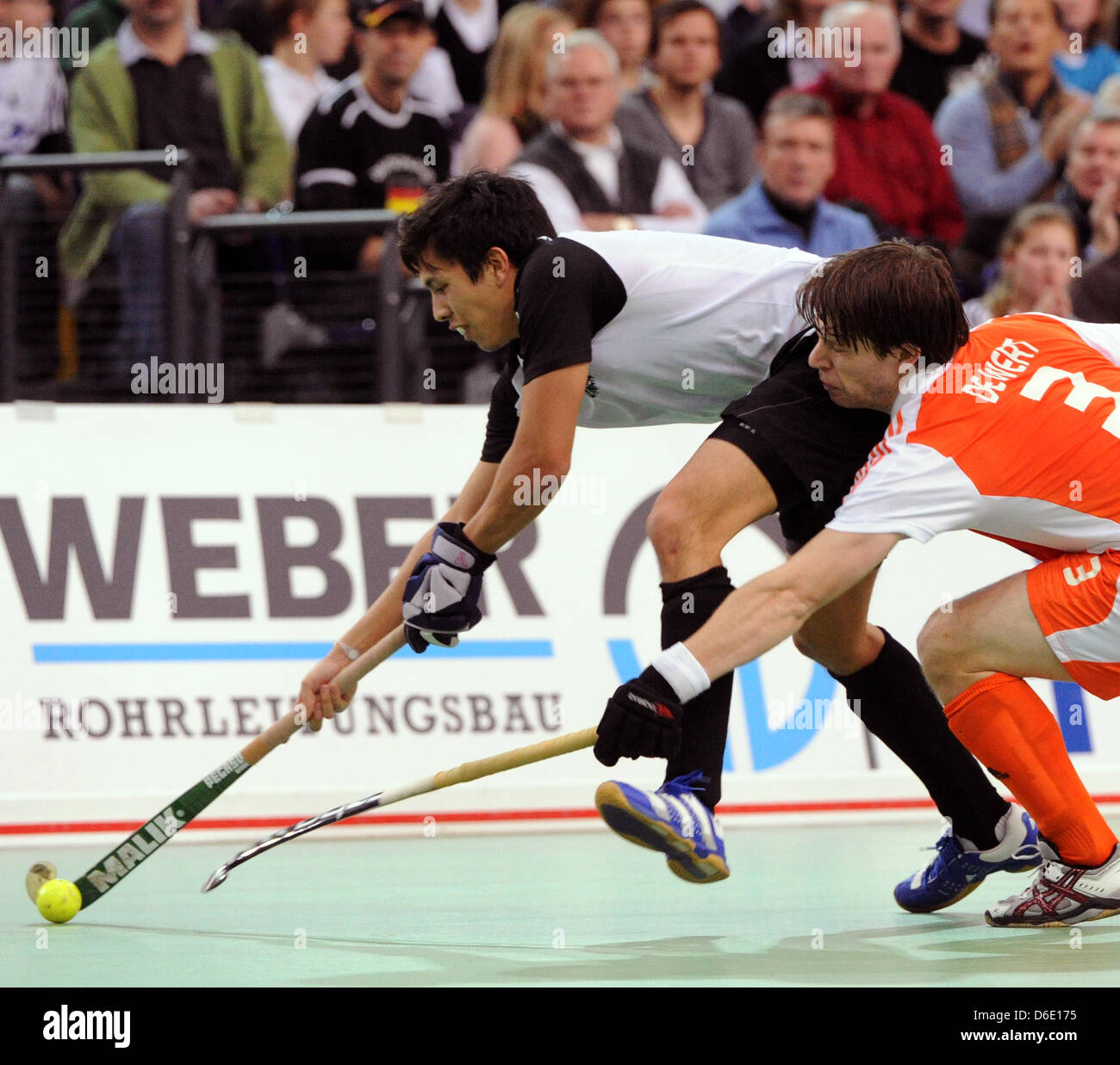 Austria's Philip Greutter (L) and Netherland's Sjoerd de Wert fight for the ball during the European Indoor Hockey Championship match between Austria and The Netherlands at the Arena Leipzig in Leipzig, Germany, 15 January 2012. Photo: HENDRIK SCHMIDT Stock Photo