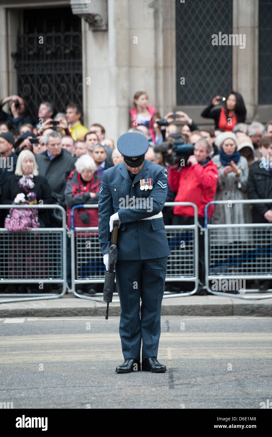 London, UK. 17th April 2013. Lady Thatcher’s coffin passes along The Strand on a gun carriage en-route to St. Paul’s Cathederal for a State Funeral. An airman on guard of honour bows his head. Credit:  Allsorts Stock Photo/Alamy Live News Stock Photo