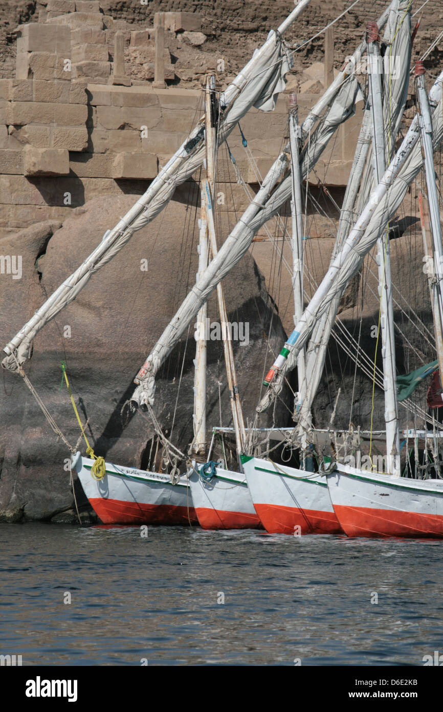 Portrait of Felucca's tied up in front of archaeological remains on the River Nile's Elephantine Island, Aswan Egypt Stock Photo