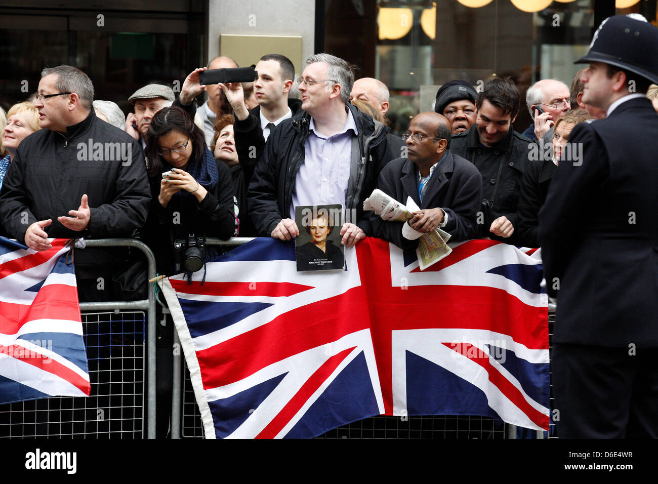 London, UK. 17th of April 2013.  The funeral of former prime minister Margaret Thatcher was held at St. Paul's Cathedral this morning. People were holding flags, flowers as well as pictures of Margaret Thatcher. Credit: Lydia Pagoni/Alamy Live News Stock Photo