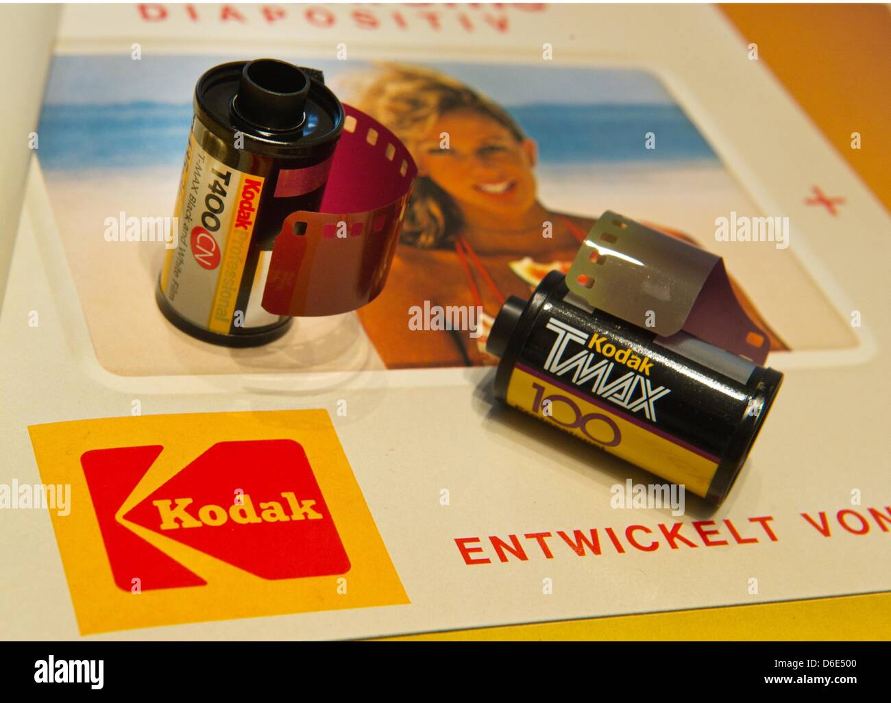 Two rolls of film for black and white photos of Kodak lie on an advertisement of the company from the year 1976 in Munich, Germany, 19 January 2012. Photography pioneer Kodak, which dominated film sales for much of the 20th century, has been in talks with banks to file for bankruptcy. According to official statements of Kodak on 19 January 2012, the company intends to continue work Stock Photo