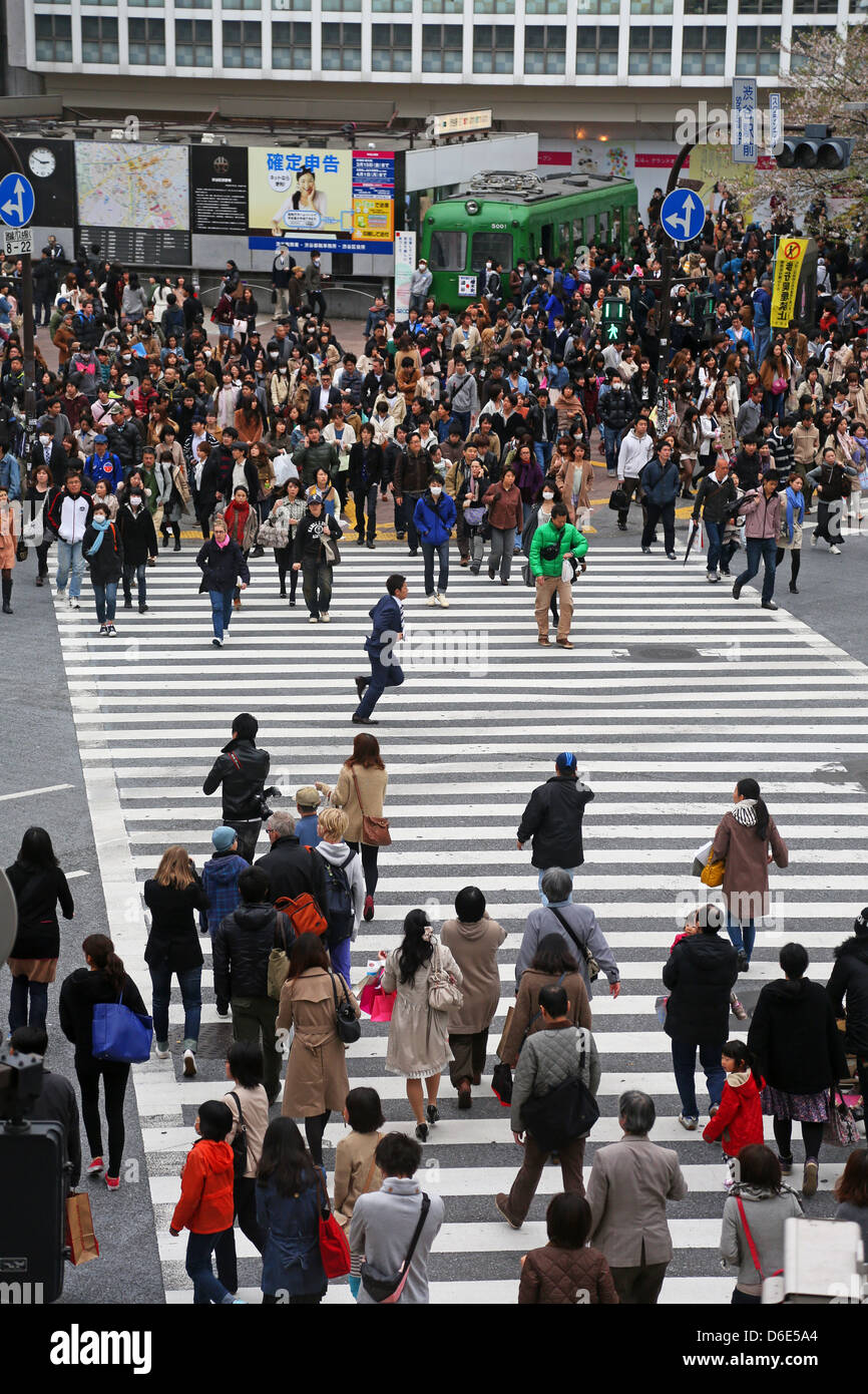 Japanese Street Scene Showing Crowds Of People Crossing The Street On A