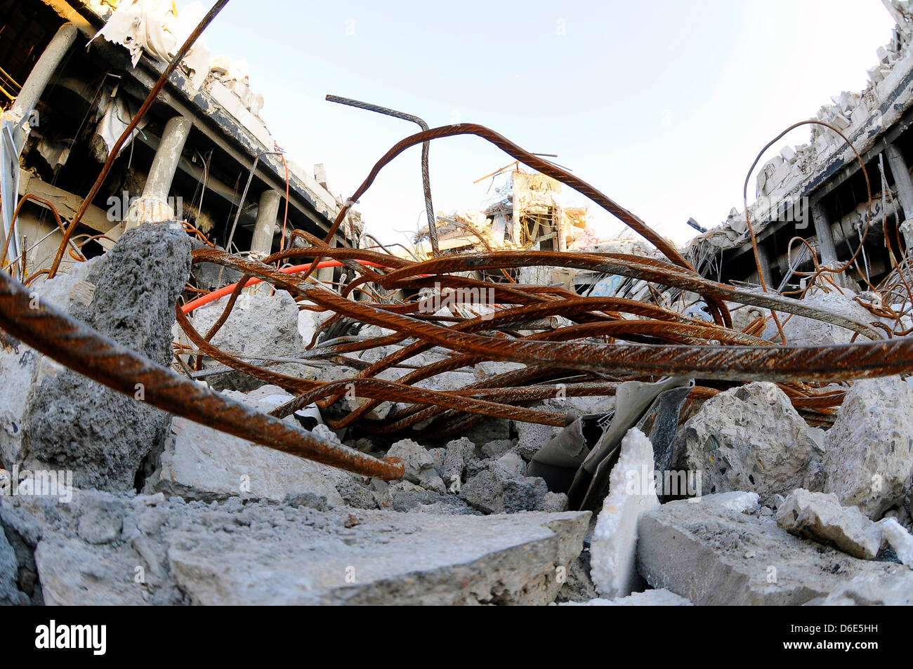 Cables, wires and steel pierce through the rubble of a destroyed office building in the Bab al-Azizia district of Tripoli, Libya, 3 December 2011. The district of Bab al-Azizia was one of the targets of intensified NATO bombing campaigns starting from the end of March 2011 during the Libyan civil war. The area accmmodated various government palaces, adminstration offices and the mi Stock Photo