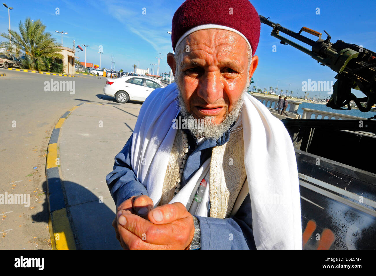 An elderly man stands next to vehicle with a mounted makeshift gun on a street in Tripoli, Libya, 17 December 2011. Local residents and civilians are making regular tours to the rebels in the Libyan capital of Tripoli to show their respect. Photo: Matthias Toedt Stock Photo