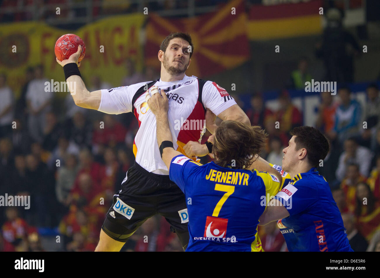 Germany's Michael Haass (L-R) attempts a jump shot against Sweden's Magnus Jernemy and Kim Andersson during the Handball  European Championship group B match between Germany and Sweden in Nis, Serbia, 19 January 2012. Photo: Jens Wolf Stock Photo