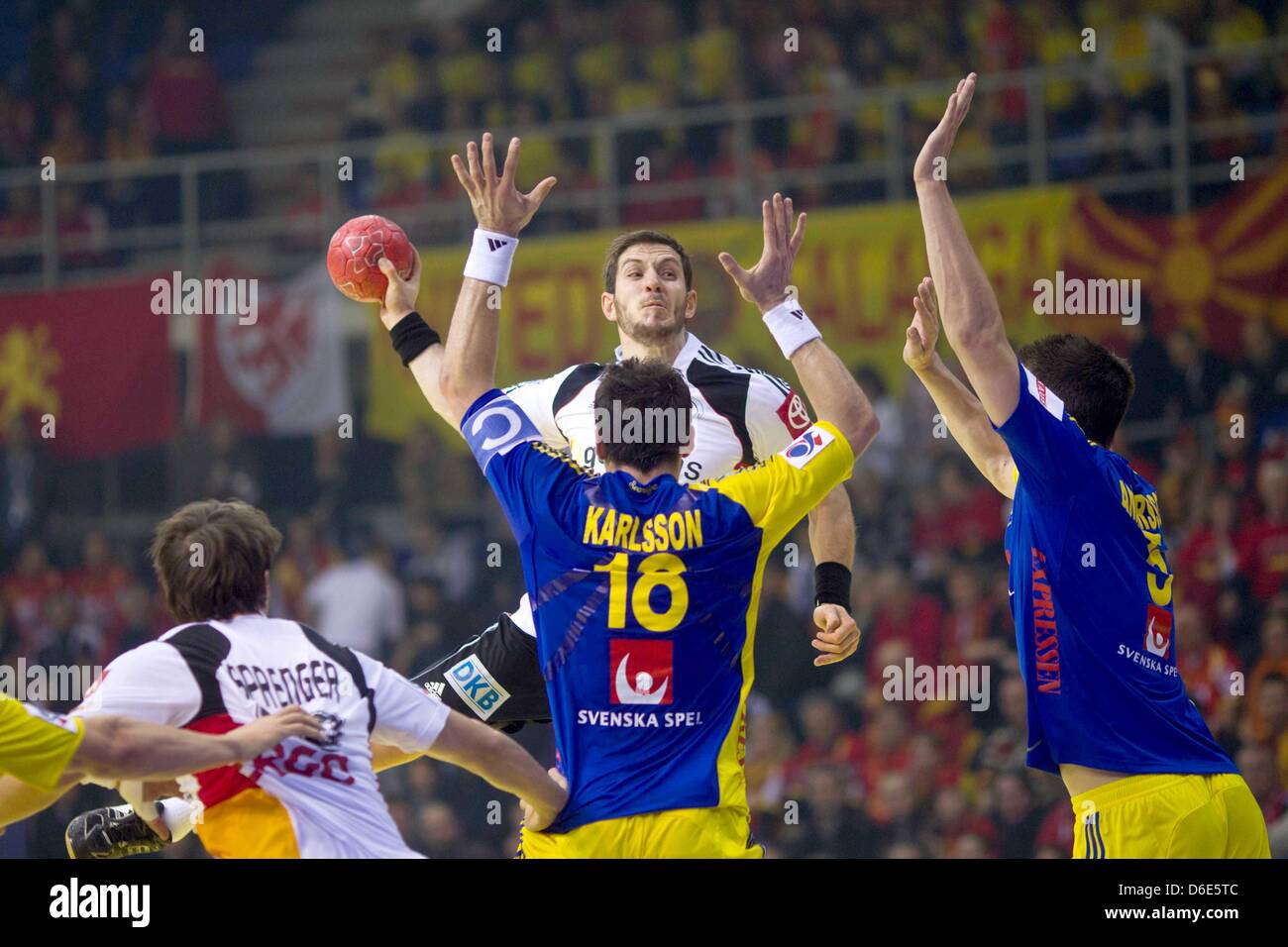Germany's Michael Haass (C) attempts a jump shot against Sweden's Tobias Karlsson and Kim Andersson (R) during the Handball  European Championship group B match between Germany and Sweden in Nis, Serbia, 19 January 2012. Photo: Jens Wolf Stock Photo