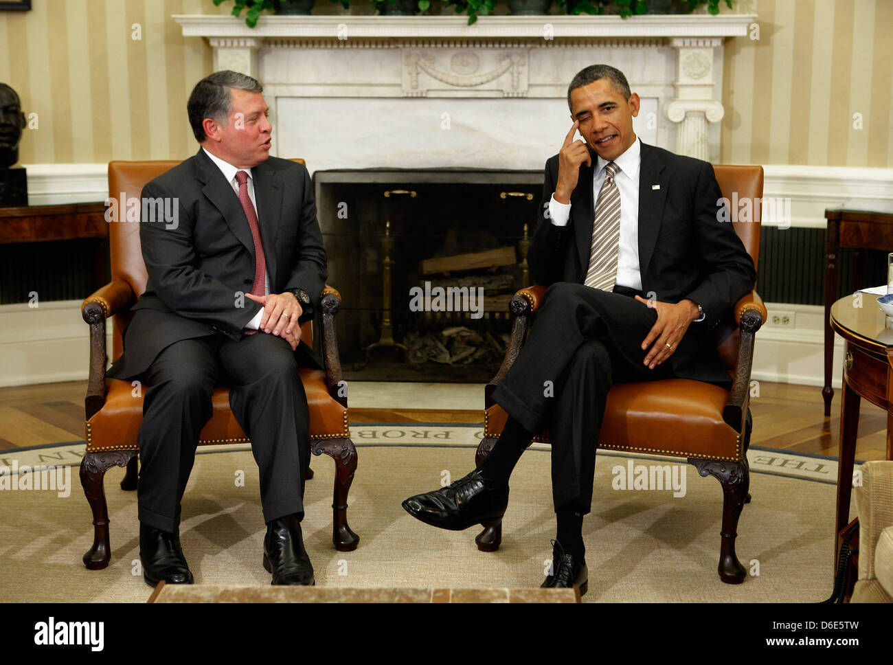 United States President Barack Obama R and King Abdullah II of Jordan talk to each other after delivering remarks to the news media following a meeting in the Oval Office at the