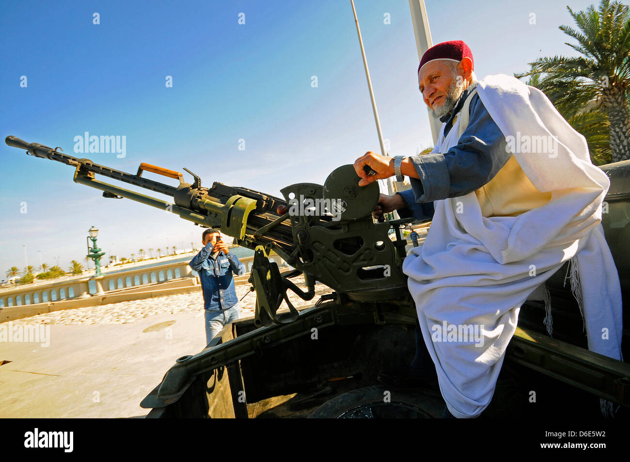 An elderly man sits to vehicle with a mounted makeshift gun on a street in Tripoli, Libya, 17 December 2011. Local residents and civilians are making regular tours to the rebels in the Libyan capital of Tripoli to show their respect. Photo: Matthias Toedt Stock Photo