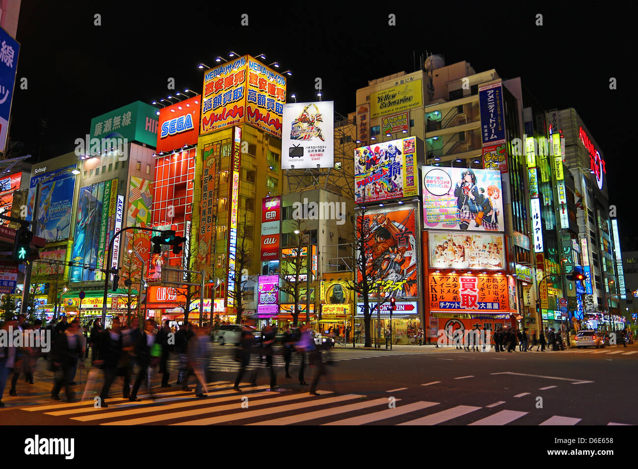 Lights of shops and buildings of Akihabara Electric Town street scene with a pedestrian crossing in Tokyo, Japan Stock Photo