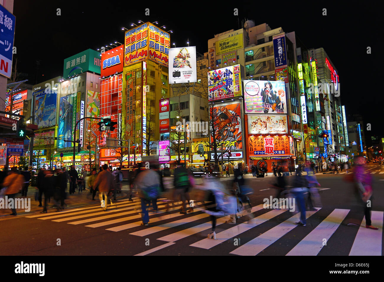 Lights of shops and buildings of Akihabara Electric Town street scene with a pedestrian crossing in Tokyo, Japan Stock Photo