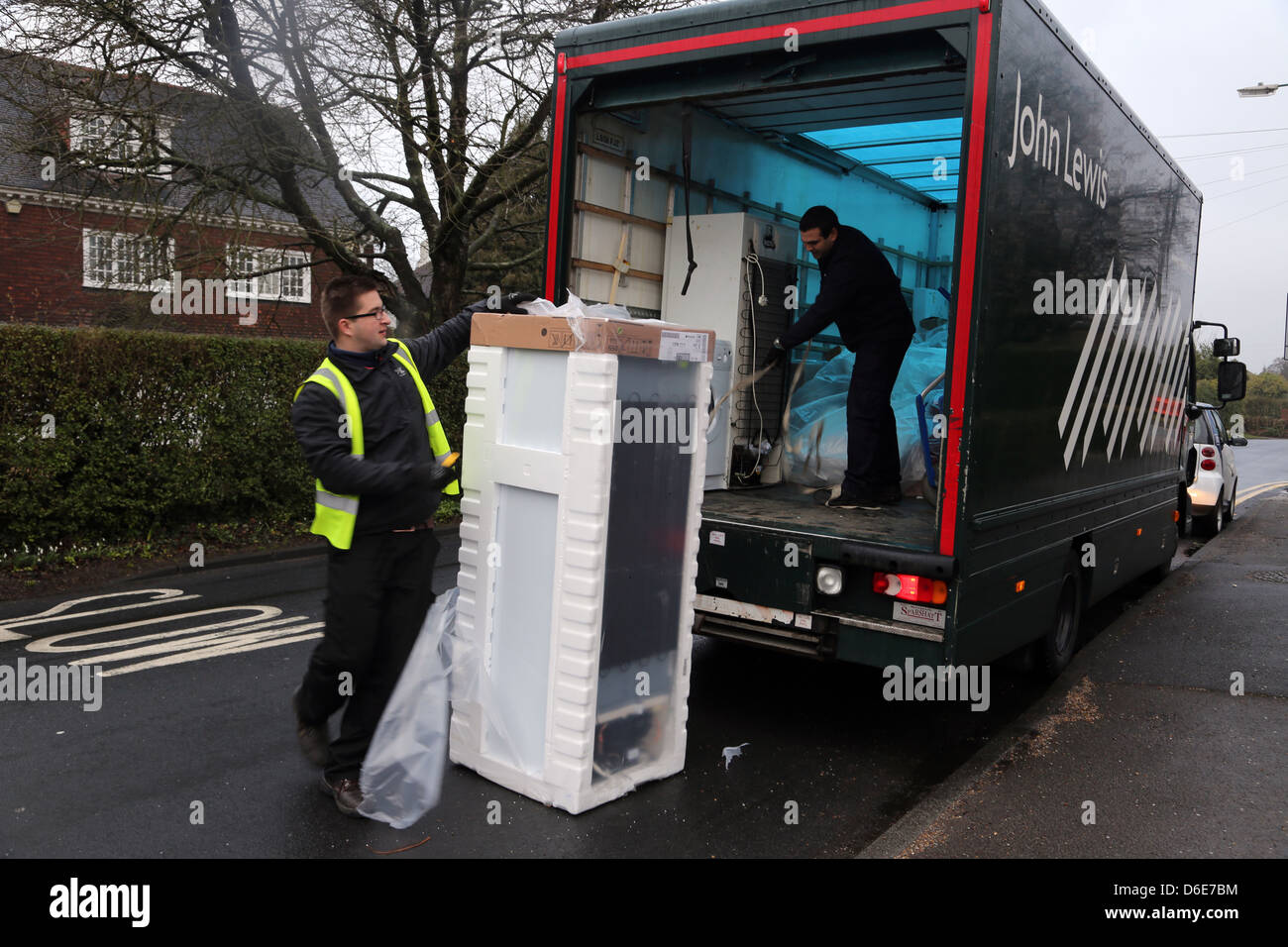 John Lewis Delivering A Freezer Man Unpacking Freezer By Lorry England Stock Photo