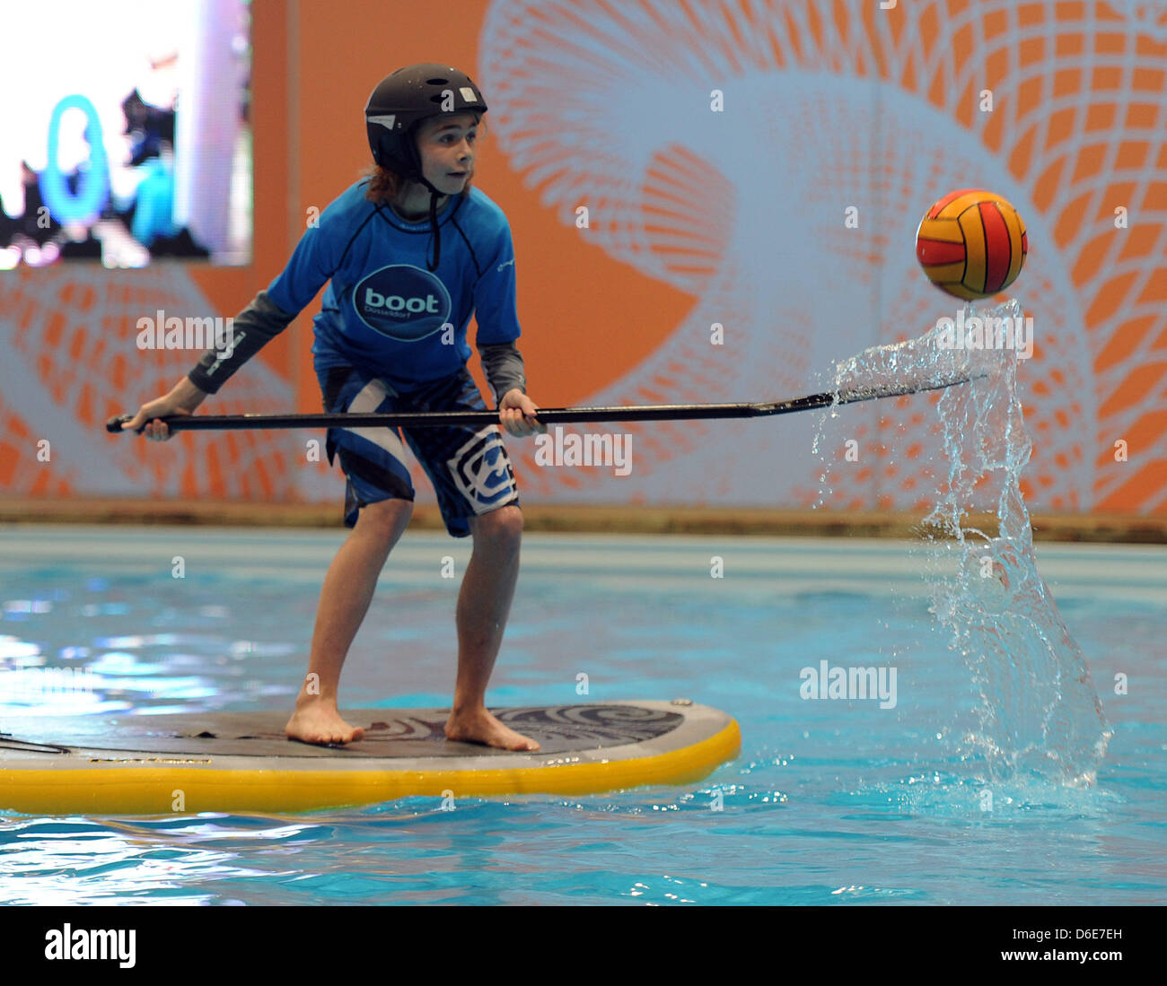 A visitor plays "Stand Up Paddling Polo" on the first day of the