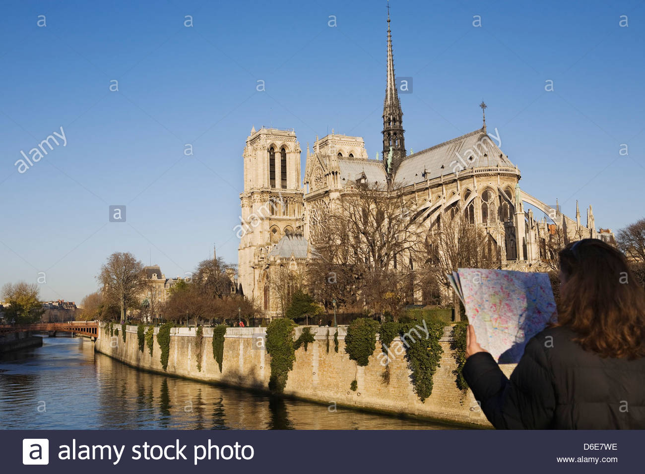 Woman Looking Map With Notre Dame Cathedral In Background Paris