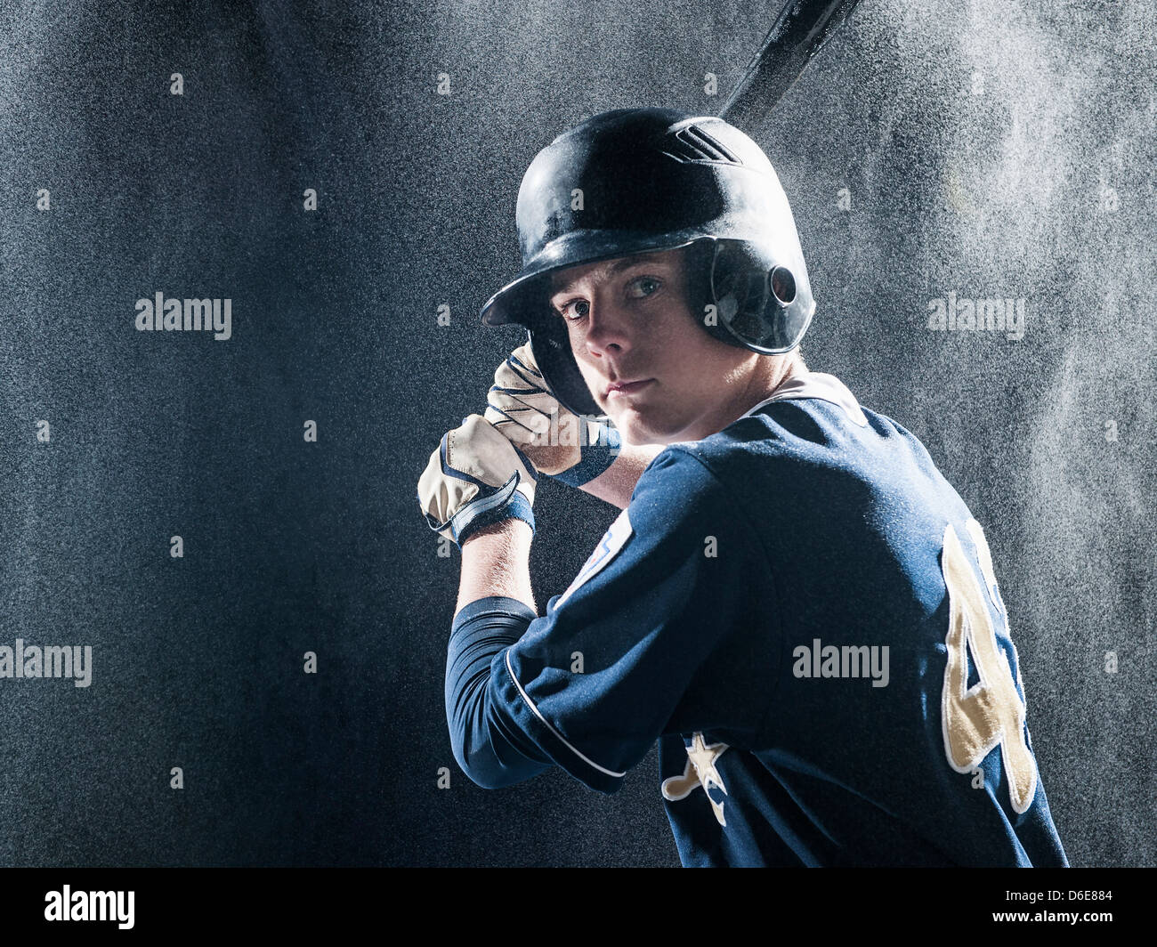 Caucasian baseball player standing in rain Stock Photo Alamy
