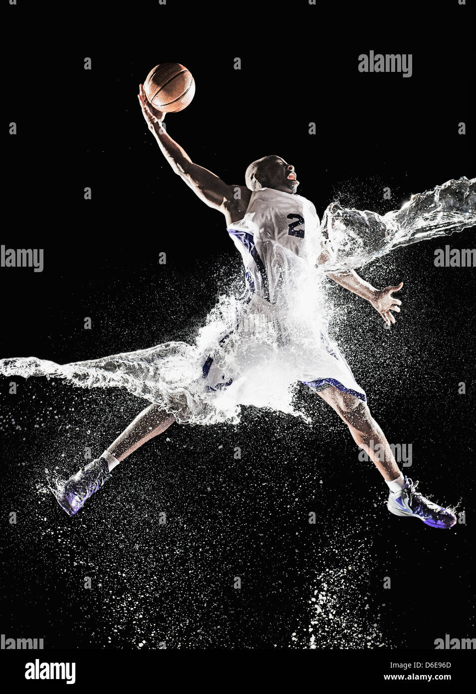 African American basketball player splashing in water Stock Photo Alamy