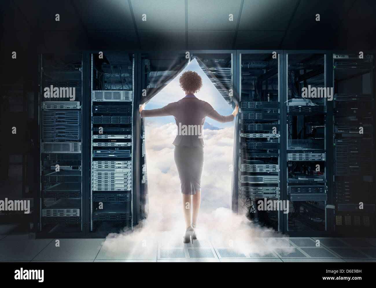 African American businesswoman walking into clouds Stock Photo