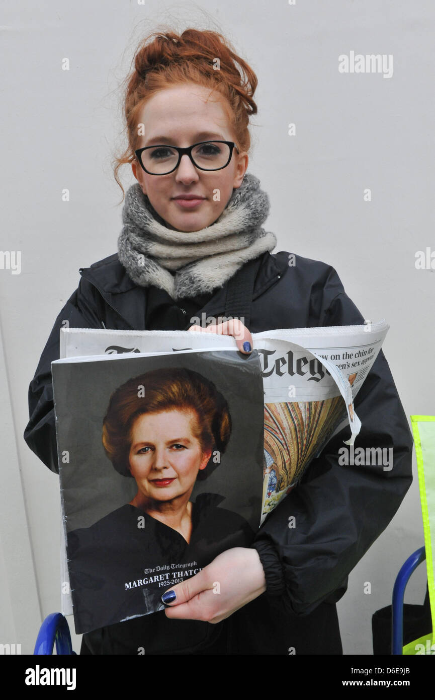 Aldwych, London, UK. 17th April 2013. A woman sells copies of The Telegraph Newspaper outside St Clement Danes Church. The funeral procession of Baroness thatcher takes place along the streets of central London. Credit: Matthew Chattle/Alamy Live News Stock Photo