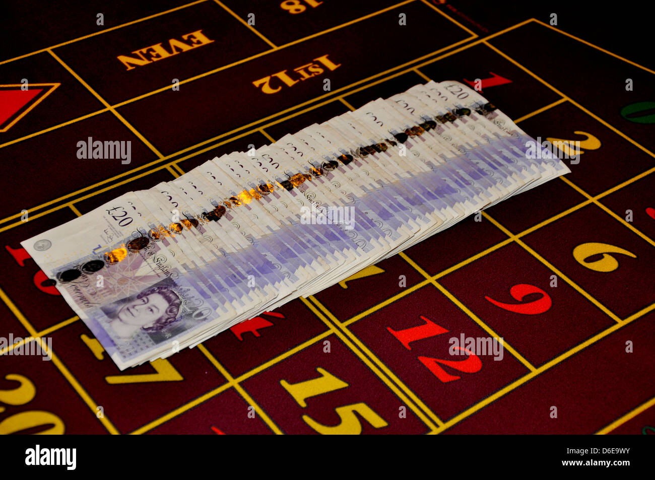 roulette casino table with twenty pound notes english money united kingdom one thousand pounds in straight line Stock Photo