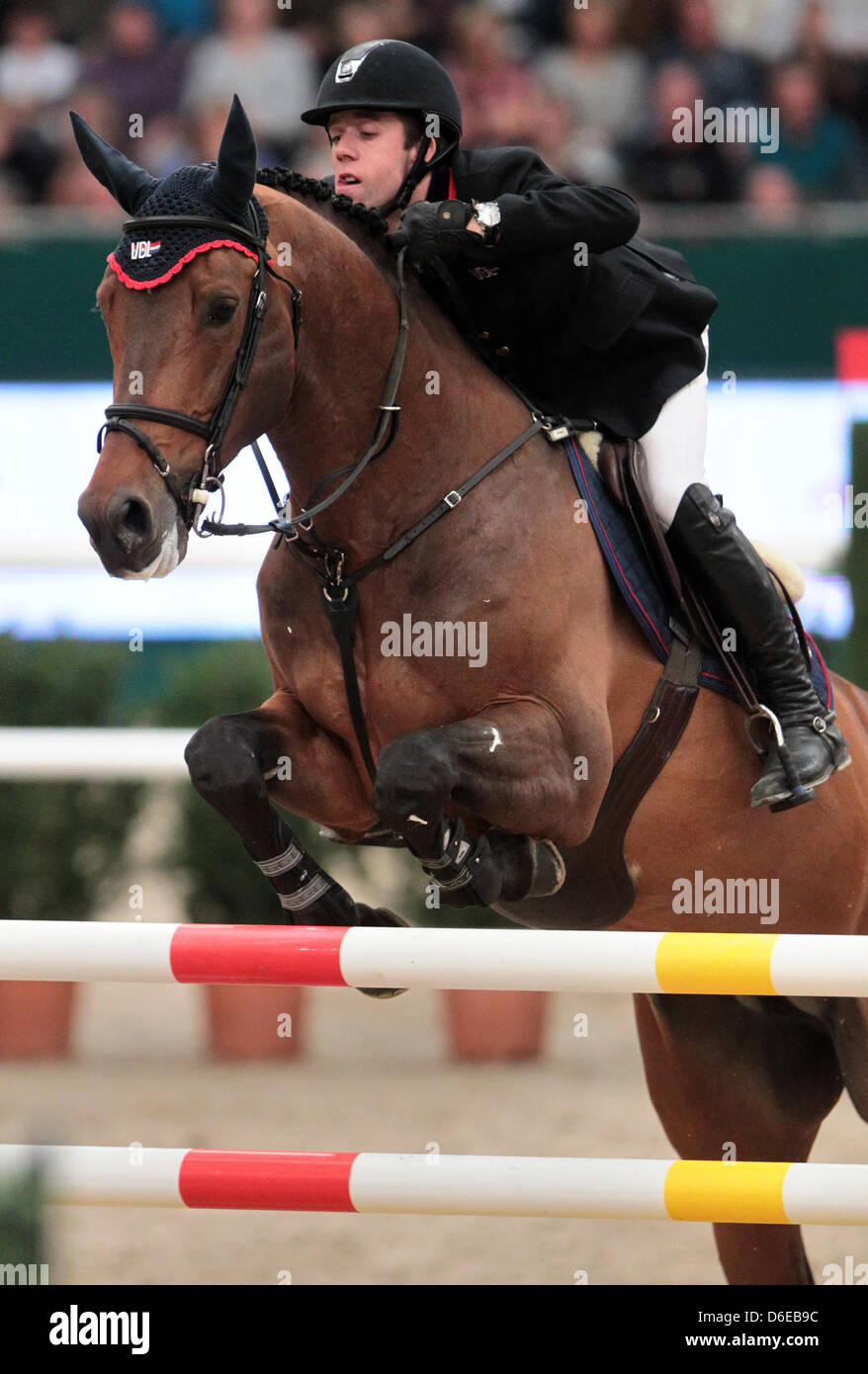 Dutch rider Maikel van der Vleuten jumps over a hurdle on VDL Groep ...