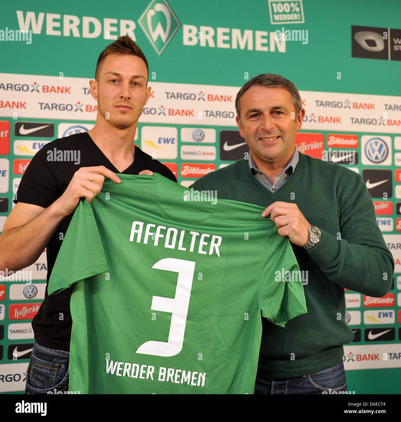 Werder Bremen's Swiss new arrival Francois Affolter (L) and Werder's managing director Klaus Allofs hold Affolter's new jersey at Weserstadion in Bremen, Germany, 25 January 2012. The 20 year old defender came from the Young Boys Bern on a one-year loan. Photo: CARMEN JASPERSEN Stock Photo