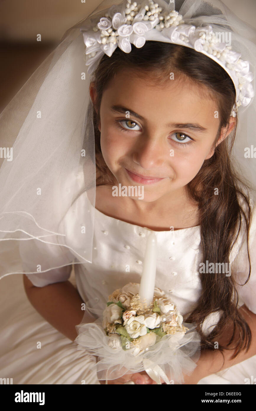 Child in holy communion dress Stock Photo