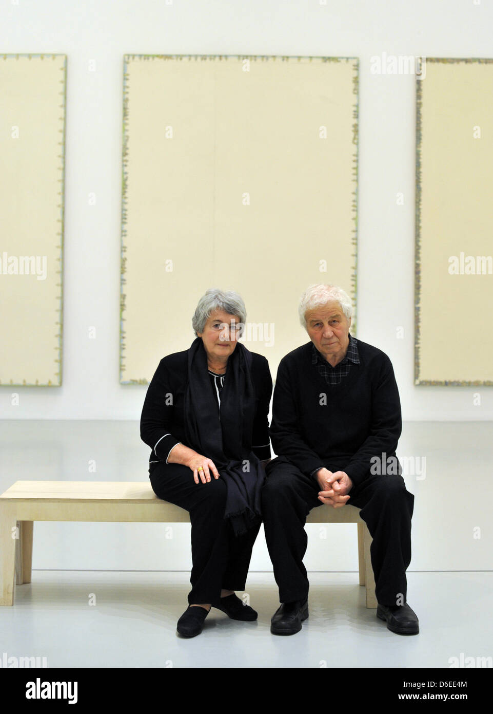 Artist Ilya Kabakov sits with his wife Emilia Kabakov on a bench in front of his works during the opening of the exhibition at the Sprengel Musuem in Hanover, Germany, 27 January 2012. The museum is showing around 60 paintings and three installations for the first time. The exhibition 'A Return to Painting' can be seen from 29 January until 06 May 2012. Photo: BARBARA PREKOPOVA Stock Photo