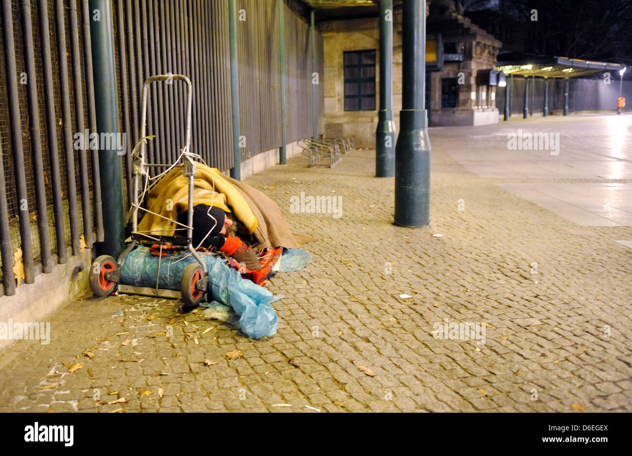 A homeless is sleeping on the street in Berlin, Germany, 30 January 2012. Berlin's emergency shelters are fully booked out. The demand of sleeping places is even greater than the current supply. Photo: Maurizio Gambarini Stock Photo