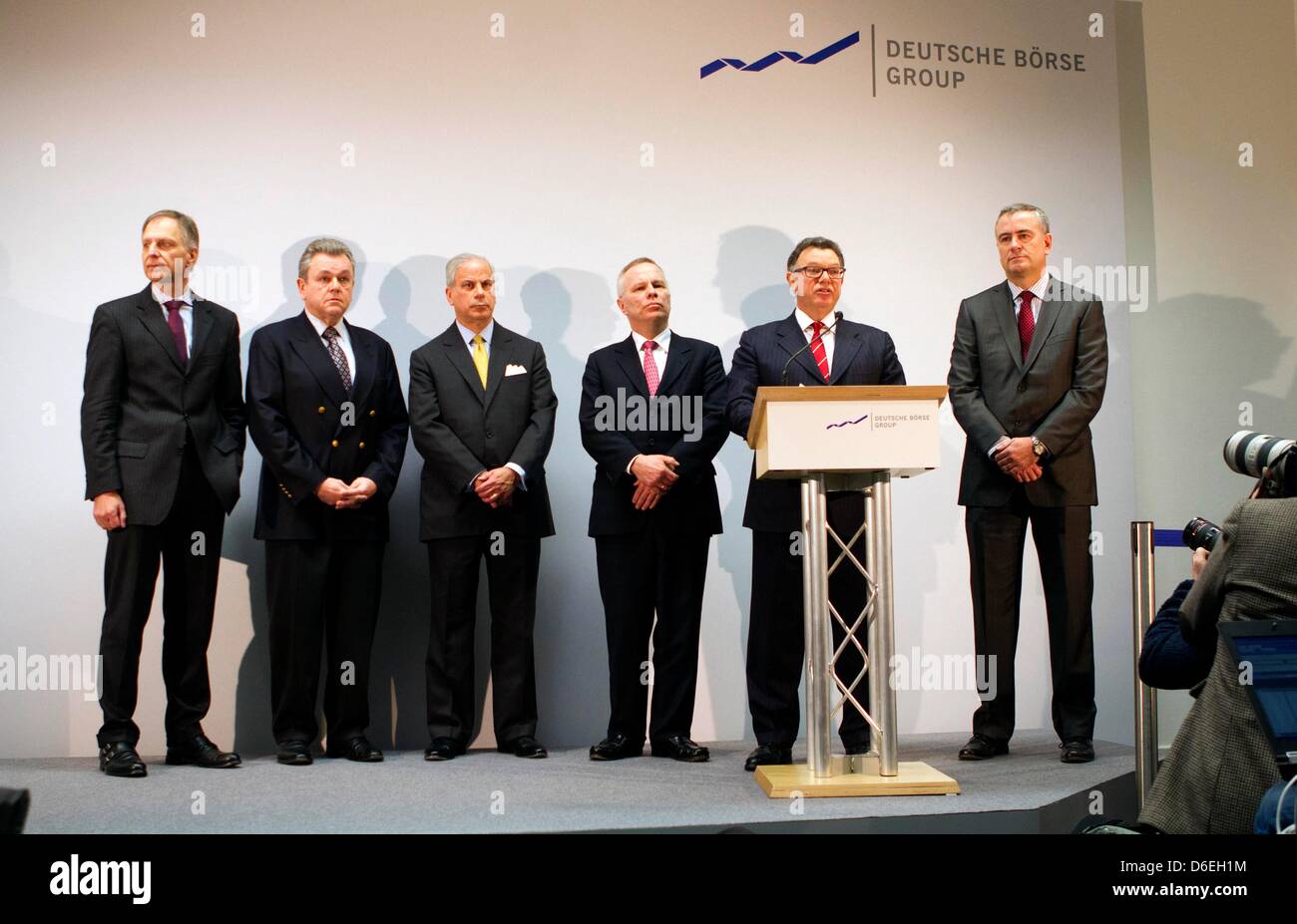 Board members of the Deutsche Boerse Frank Gerstenschlaeger (L), Michael Kuhn (2-L), Jeffrey Tessler (3-L), Andreas Preuss (4-L) and Gregor Pottmeyer (R) stand on the stage while a CEO Reto Francioni (2-R) talks about the No to the planned merger of his company with the NYSE Euronext in New York by the EU Commission in Frankfurt Main, Germany, 01 February 2012. Almost exactly a yea Stock Photo