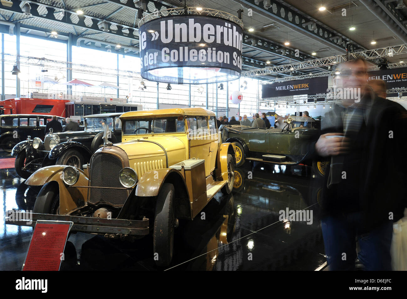 Visitors walk past an unrestored cars from Schlumpf Collection of the