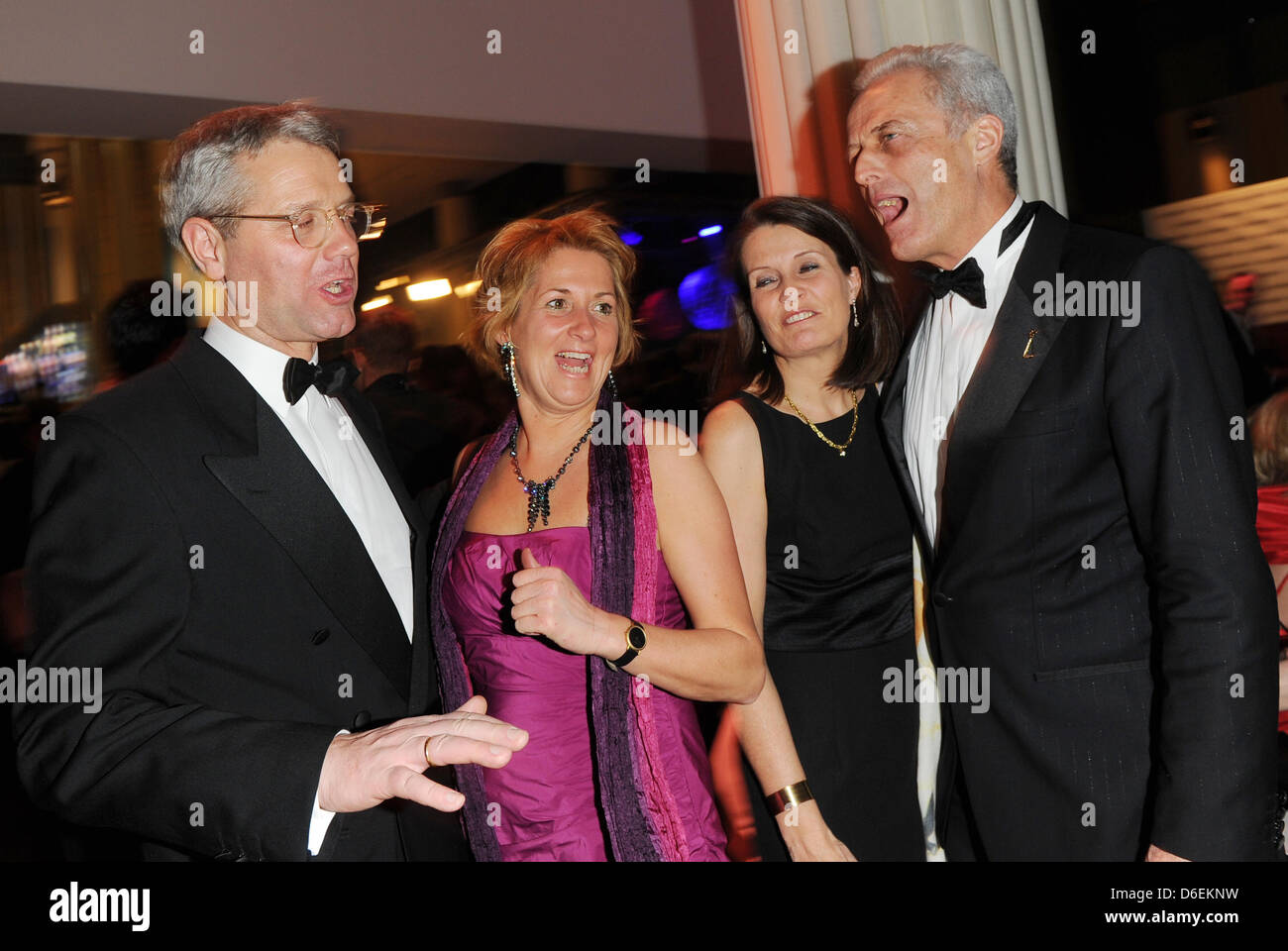 German politician Norbert Röttgen (L-R), Federal Minister for the Environment, Nature Conservation and Nuclear Safety, and his wife Ebba Herfs-Röttgen and German minister of transport Peter Ramsauer (R) and his wife Susanne celebrate during the party of 47th Golden Camera award in Berlin, Germany, 4 February 2012. The award honours outstanding achievements in television, film and e Stock Photo