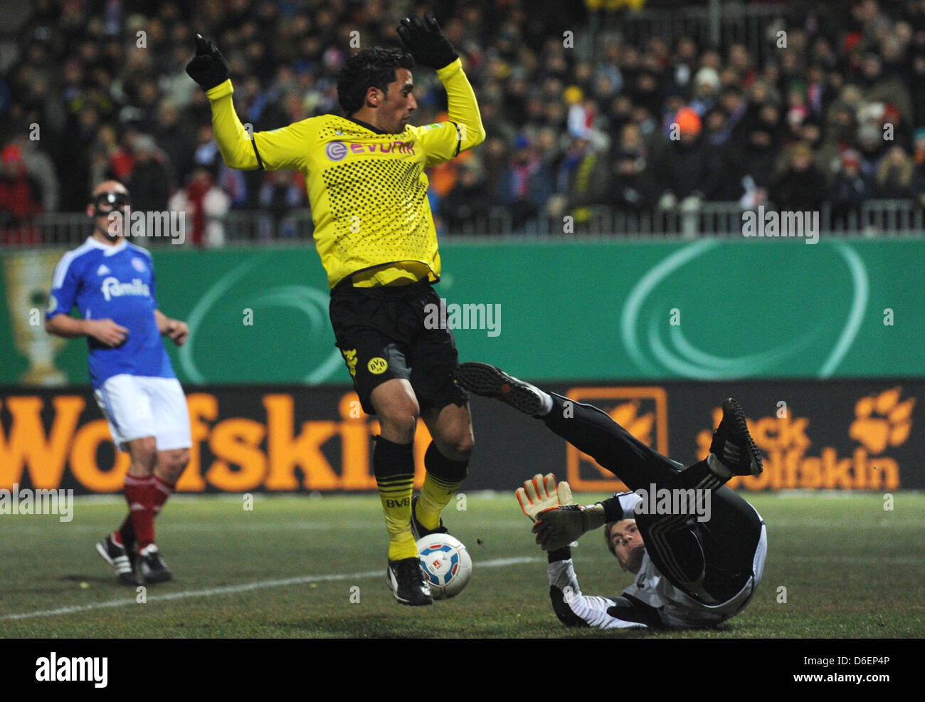 Kiel's goal keeper Morten Jensen (R) and Dortmund's Lucas Barrios fight for the ball during the DFB Cup soccer match between Holstein Kiel and Borussia Dortmund at the Holstein Stadium in kiel, Germany, 07 February 2012. Photo: Marcus Brandt Stock Photo