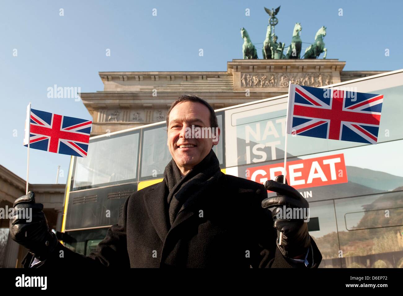 British Ambassador Simon McDonald poses in front of a double-decker bus of the Berlin Transport Services (BVG) with the advertisement slogan 'Natur is Great Britain' in front of the Brandenburg Gate in Berlin, Germany, 08 February 2012. The world wide advertisement campaign for Great Britain on the occasion of the Olympic and Paralympic Games in 2012 started today. Photo: SEBASTIAN Stock Photo