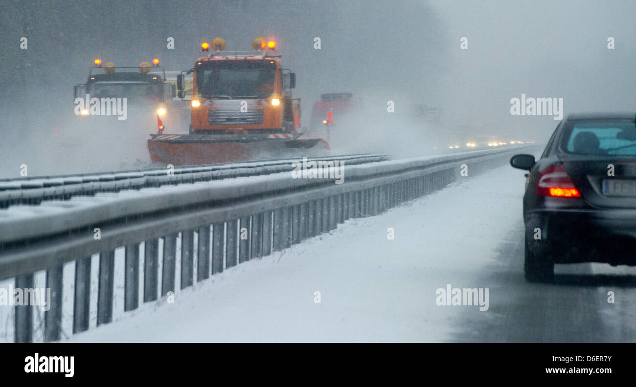 Snowploughs of a motorway clearing service drives down the A12 motorway near Fuerstenwalde, Germany, 09 February 2012. Photo: Patrick Pleul Stock Photo