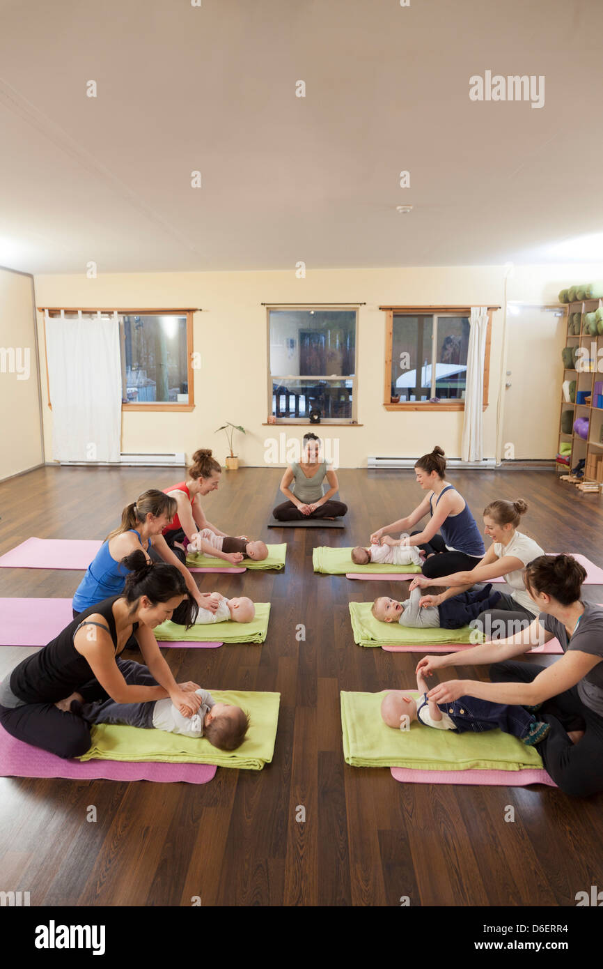Mothers and babies taking yoga class Stock Photo Alamy