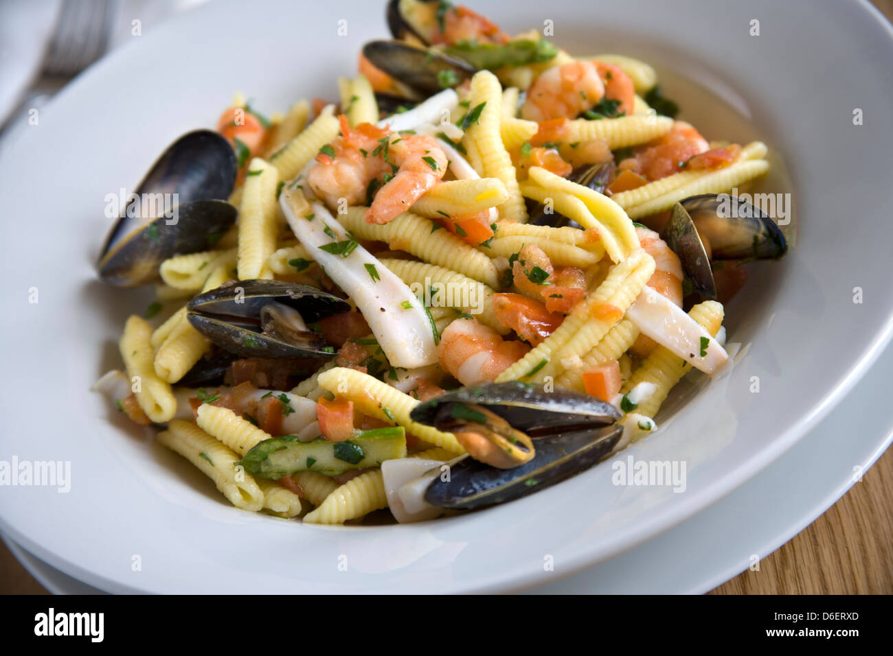 Pasta with mussels, prawns, squid , tomato, olive oil, garlic and herbs