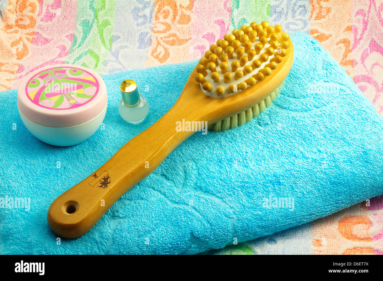 Wooden light brown brush with the long handle for body massage. Has wooden balls for massage and a rigid bristle for skin massag Stock Photo