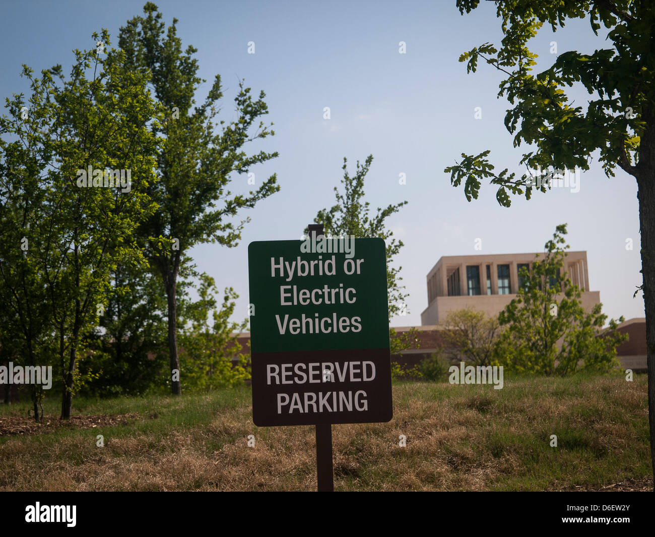 In the visitor parking lot next to handicap parking spots are spaces reserved for hybrid or electric vehicles. Presidential library and museum for the 21st century it is landscape with drought tolerant native plants, buffalo grass, has lots of bicycle racks and rewards those who use less fossil fuel. Stock Photo