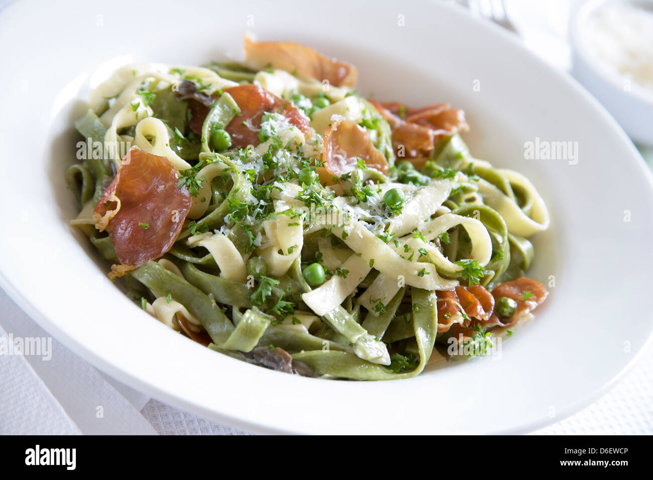 Tagliatelle pasta with cream, Parma Ham, garlic, mushrooms, peas and Parmesan Stock Photo Alamy