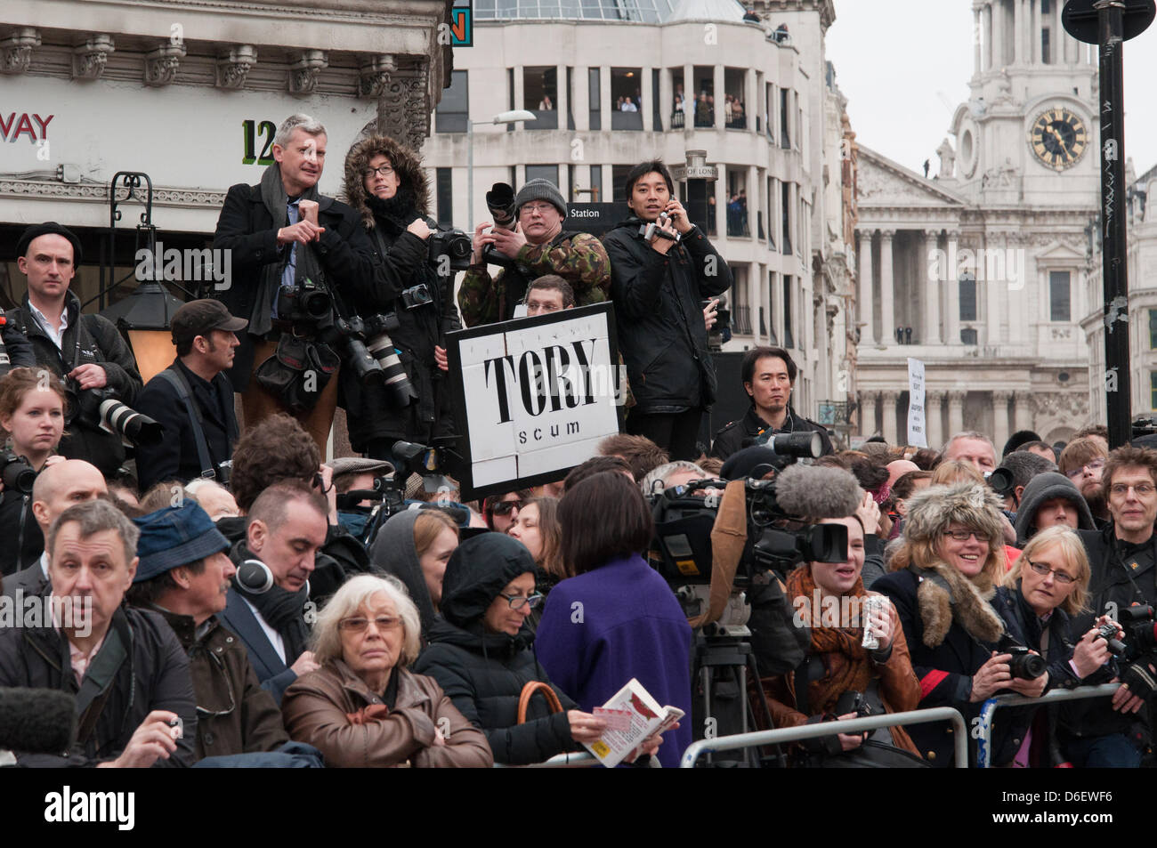 London, England UK 17/04/2013. The press pack mingles with protesters waiting for the gun carriage bearing Margaret Thatcher's coffin on Ludgate Circus.  Protesters turned their back as the coffin approached and chanted 'waste of money' at the military procession. Stock Photo