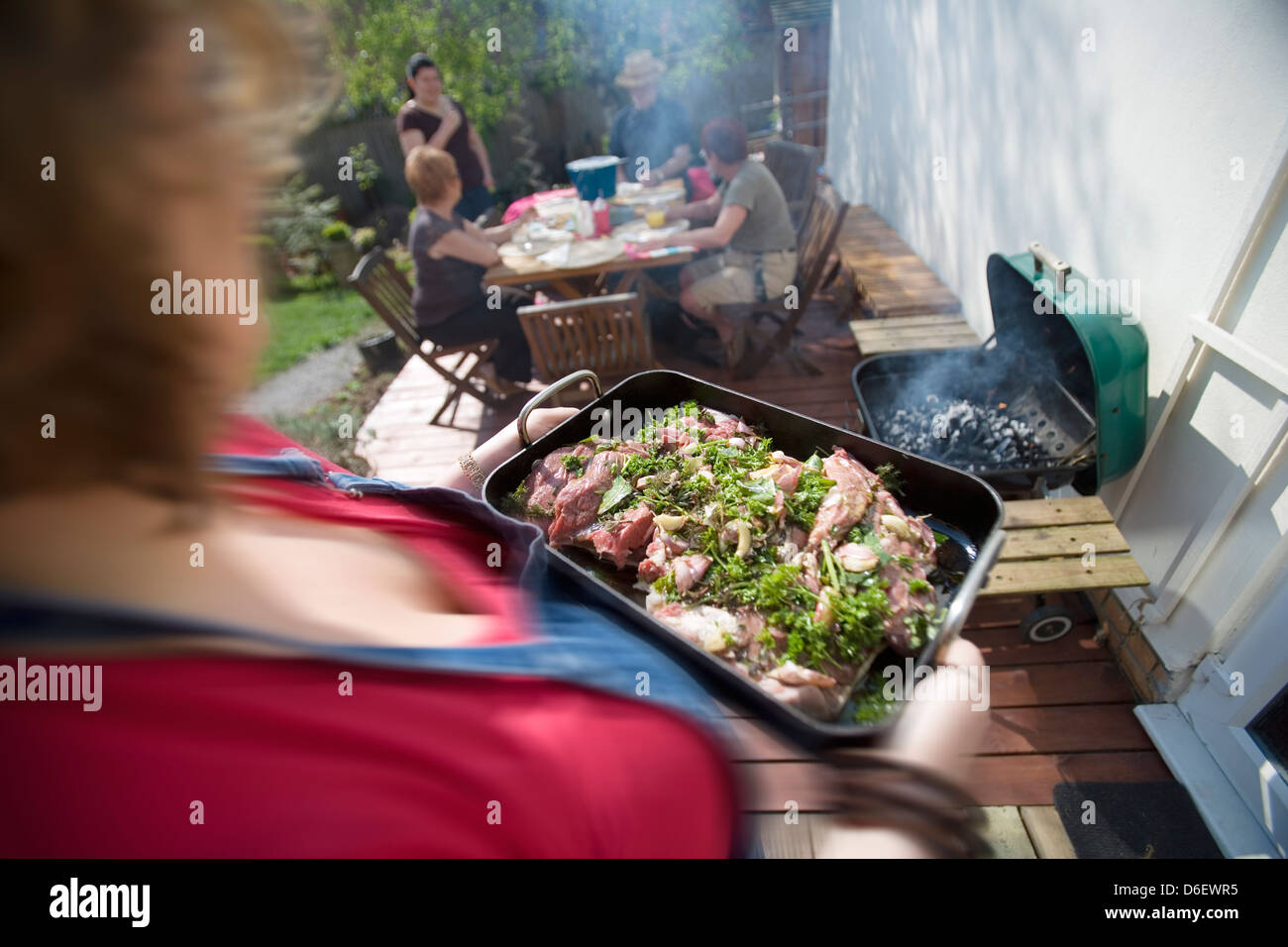 Marinated lamb being carried to the barbecue Stock Photo - Alamy