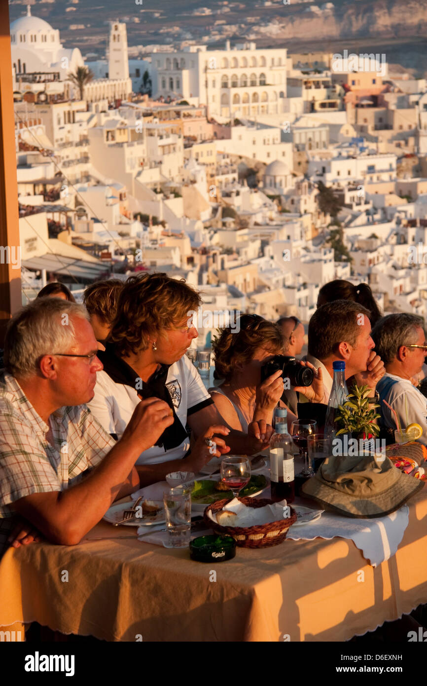 Dining at a caldera view restaurant on the Greek island of Santorini or Thira, Cyclades, Greece Stock Photo