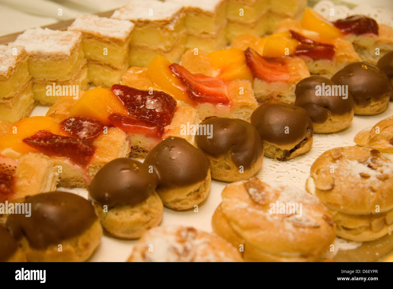 mini cakes and pastries on the dessert buffet of a cruise ship Stock