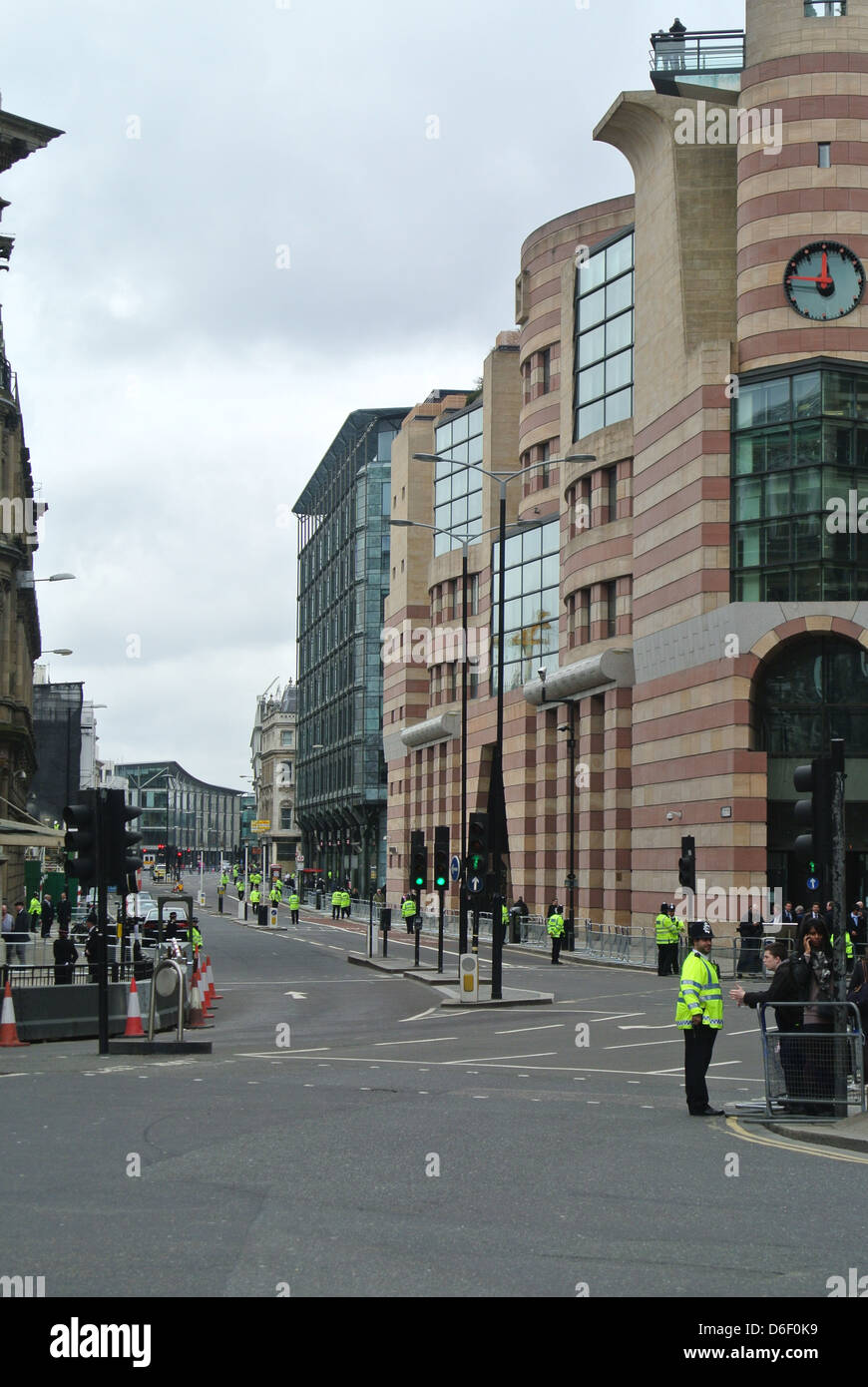 Empty roads, no traffic, cars, buses. Day of Margaret Thatchers funeral. Line of police. Queen Victoria St, London. Stock Photo