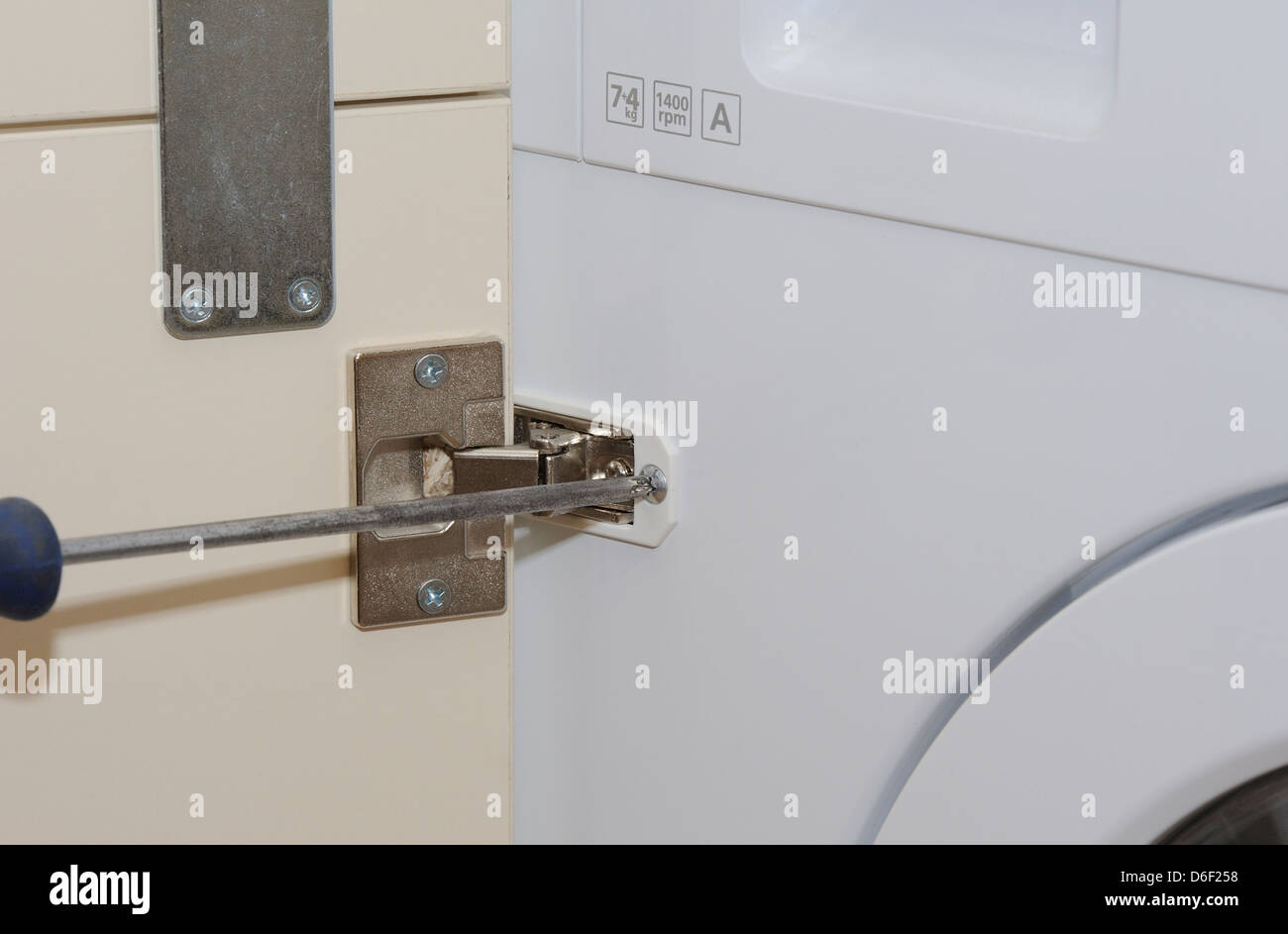A Close Up Detail Shot Of A Kitchen Door And Hinge Being Fitted To